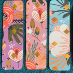 three flowery bookmarks in a row.