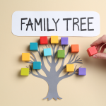 a tree with different colored blocks on the branches with a hand placing a red block.