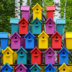 rows of birdhouses painted different colors.
