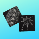 zentangle designs in white ink on black paper