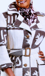 A fashion image of a Black woman wearing a black and white jacket.