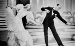 Ginger Rogers and Fred Astaire in a black and white still from Swing Time dancing gracefully in unis
