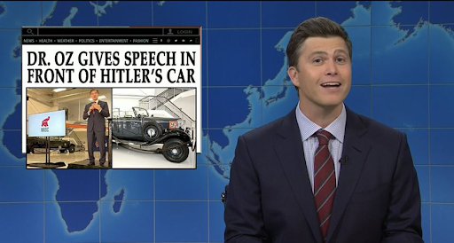 Image of SNL castmember Colin Jost hosting the Weekend Update segment and talking about Dr. Oz's speech in front of Hitler's car