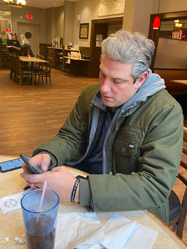 Image of Tim Ryan texting at a coffee shop Image of Tim Ryan texting at a coffee shop