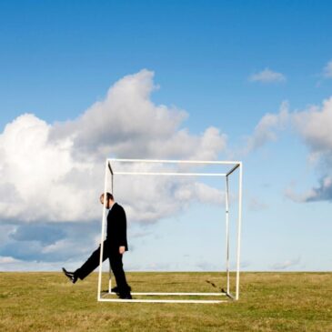 man-walking-through-a-square-in-a-field