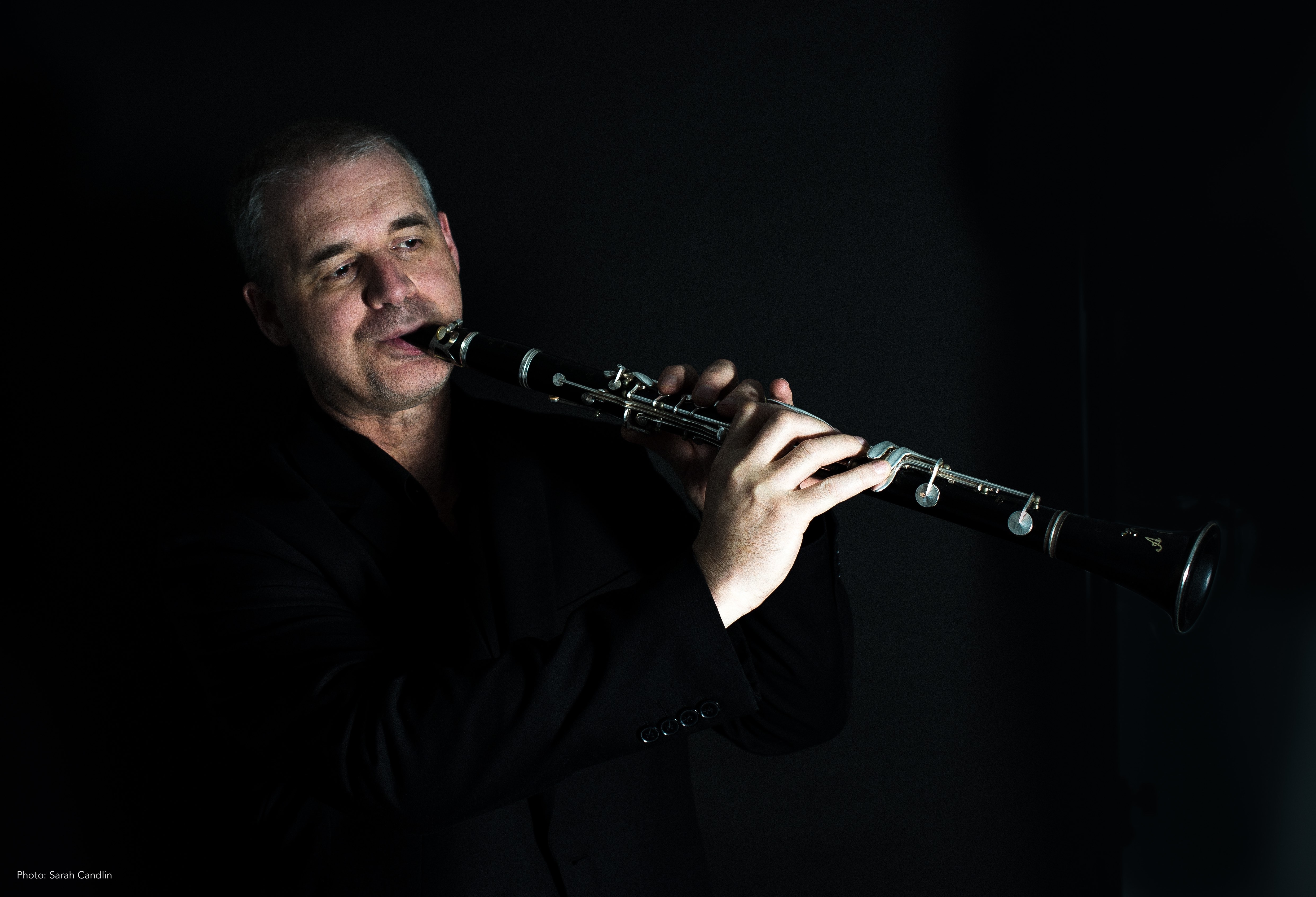 Andy Firth Playing Clarinet with a dark background. — jazz photo by Andy Firth | All About Jazz