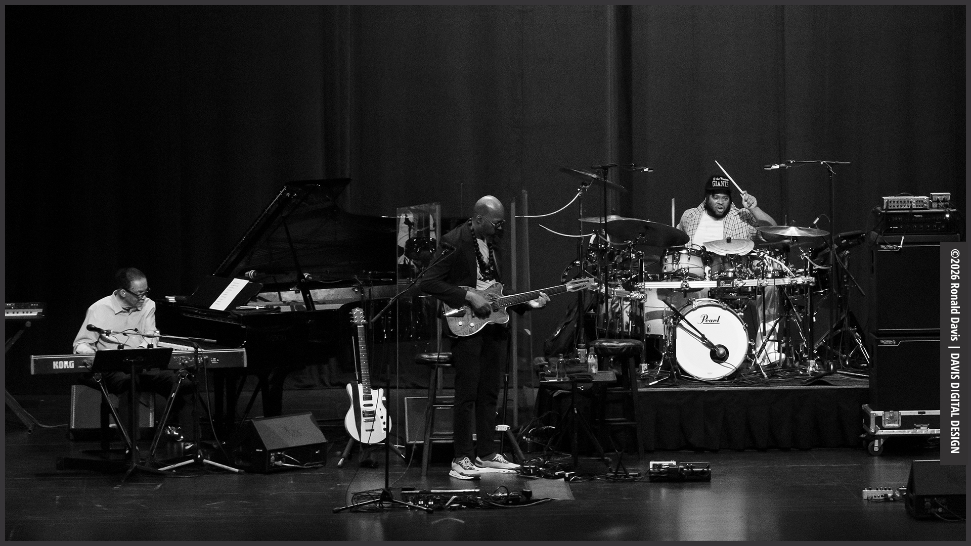 Herbie Hancock, Lionel Loueke, guitar, Jaylen Petinaud on drums — jazz photo by Ronald Davis | All About Jazz