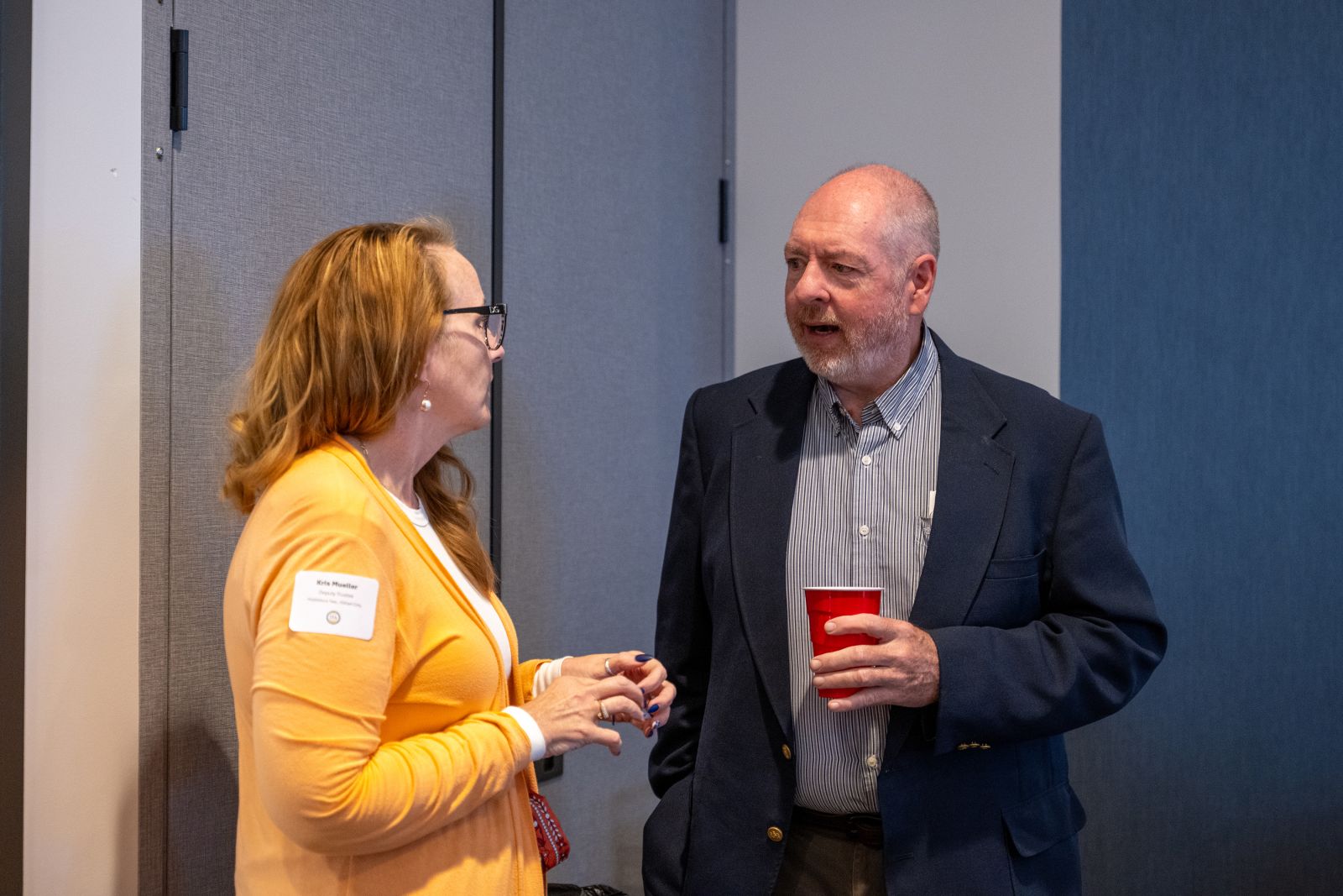 Two attendees talking over coffee