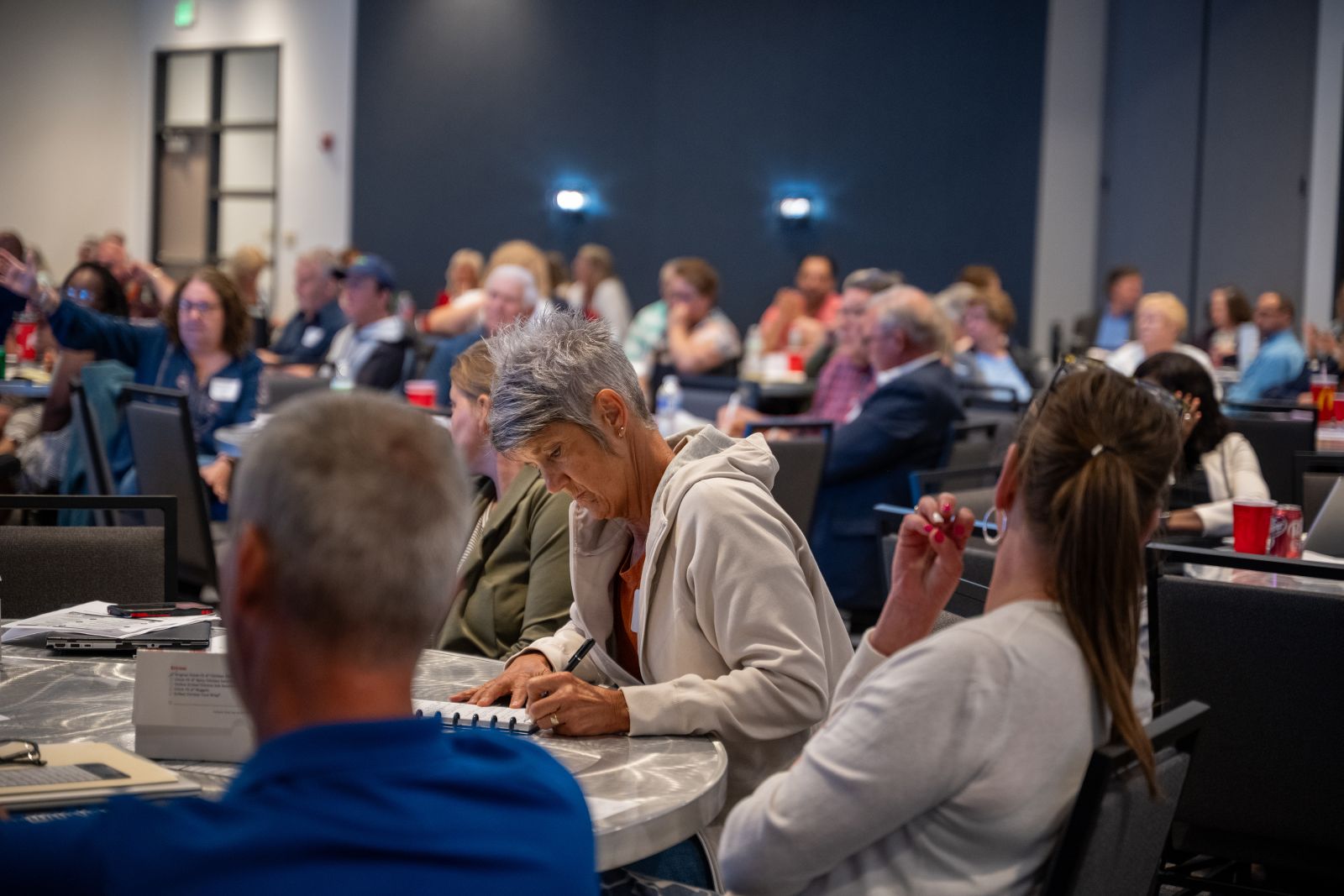An attendee taking notes during a session