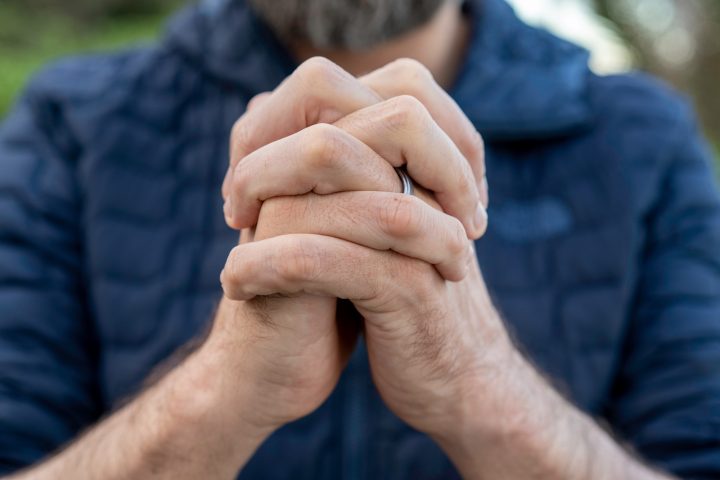 Praying hands of young man