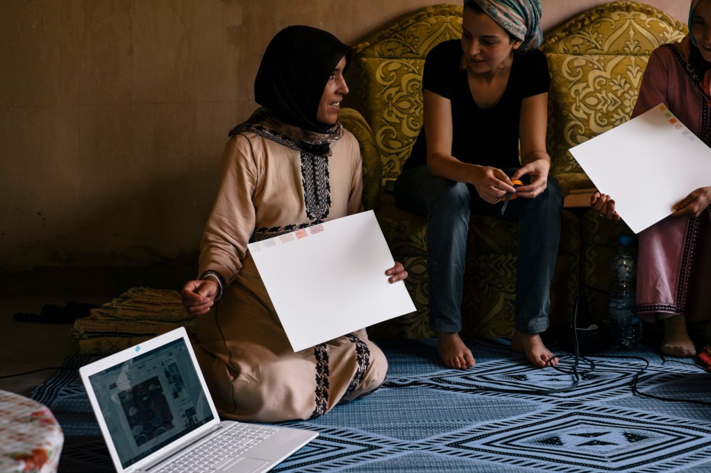 After selecting the images and their colors, each artisan explains their selection to everyone else. Here, Fatima Ouakhoum of the Cooperative of Imelghaus explains her choices. 