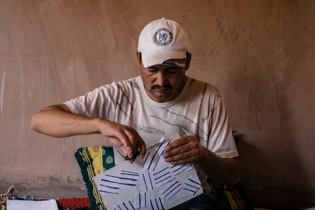 Another design technique artisans explored was to draw out a name, traditional design, or what ever else they could think of and then cut the drawing up and glue it back together all mixed up. Brahim tries this with a Beni Ourain style rug found commonly in his village. 