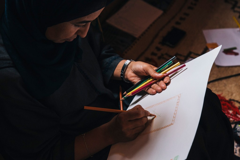 Kenza of Association Tithrite working on a new design. 