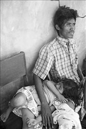 Municipal hospital is prioritizing cases that need immediate attention.  This father is waiting to hitch a ride to bring sick daughter to Davao Medical Center -- a 7 hour ride from the province to the city.: by 13thwitch, Views[870]