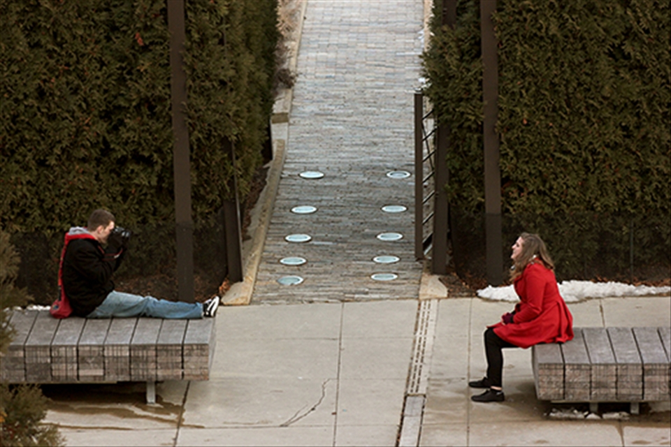 In Millennium Park, a young couple takes turns posing with the urban skyline as a backdrop. Despite the cold winter day, they wander around enjoying each other’s company. Such a simple pleasure can be so hard to find.