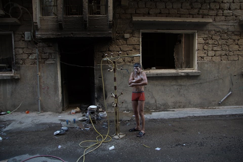 A Free Syrian Army fighter took a shower outdoors to beat the heat 