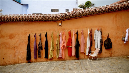 Work in the Medina: a wall of typicals moroccans dresses 