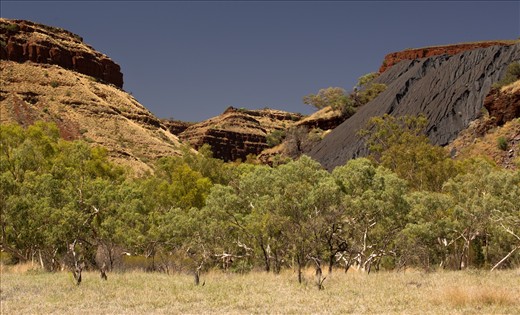 The dark grey tailings from the mine site have eroded over time, all the water holes below are now contaminated with Blue Asbestos