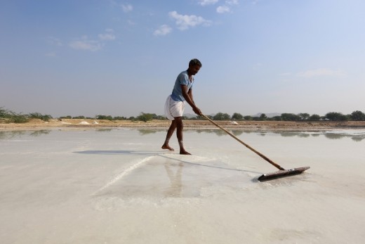 Tabula Rasa:
A man working under fierce sun, the natural spirulina salt fields still manages to looks serene, almost snow-white.