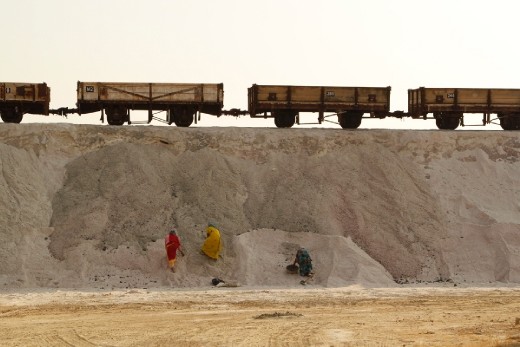 Journey:
Colorfully attired local Rajasthani women working in desert 'snow' under the crawling train-trolley system.
