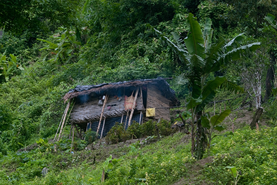 A 'Mru' indigenous home at the slope of a hill. 