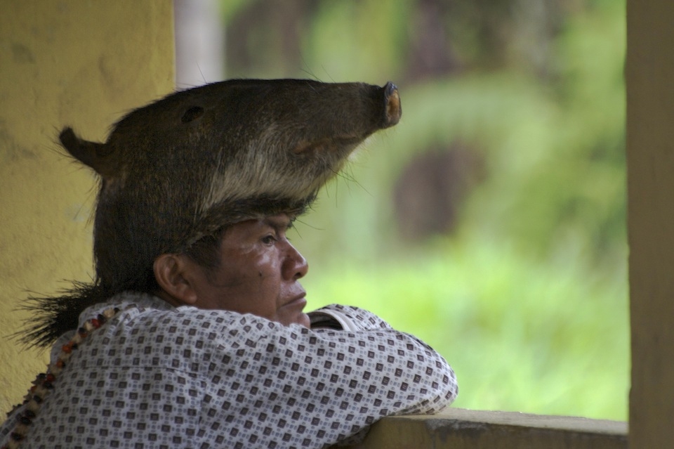 5. Jorge Santi, the tribal leader and Shaman of Kichwa people in the Pastaza region of Ecuador finds a moment alone to reflect on the political future of his region.  This marks the end of a long day of political promises and final votes. His headdress is made from the skin of a peccary head. When asked what it means to him, I was told that after taking part in a spiritual ritual involving the ingestion of a powerful psychotropic, Ayahuasca, he had visions of a sounder of Peccaries foraging in the valley below. The following day he and his hunters slaughtered some of the herd and now the taxidermied skin serves as a symbol of he and his peoples connection with the nature that they have depended on for over 10,000 years. To me, he represents archaic balance cornered by the fleeting-but-permanent change of the new world. 