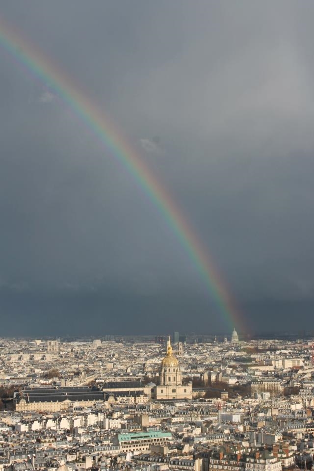Part way up the Eiffel Tower and a rainbow across Paris