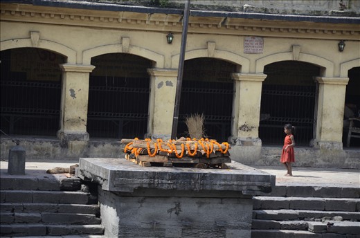 Young girl contemplating a funeral pyre