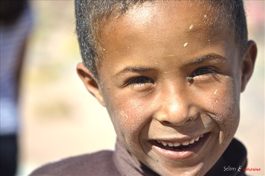 I am Happy regardless of anything. Bedouin kid in the desert  