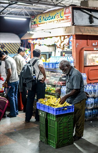  Then there was this fledgling fruit vendor who set his shop next to this other big railway stall. Most passengers chose the bigger and fancier shop for their snacking needs yet this old yet enthusiastic fruit vendor never lost any hope trying to attract customers. Although almost nobody in that one hour bought anything from him, I never saw him accept defeat to this big shop behind him. I later bought a dozen of his bananas. 