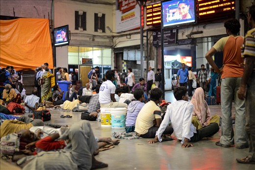 What you are seeing are not passengers waiting at the station after a schedule cancellation or delay, some of them merely come to the railway station just to watch some telly! The train schedule board is accompanied by many local TV channel sponsored TV that is meant to entertain waiting passengers. Seem like the idea has worked only too well.