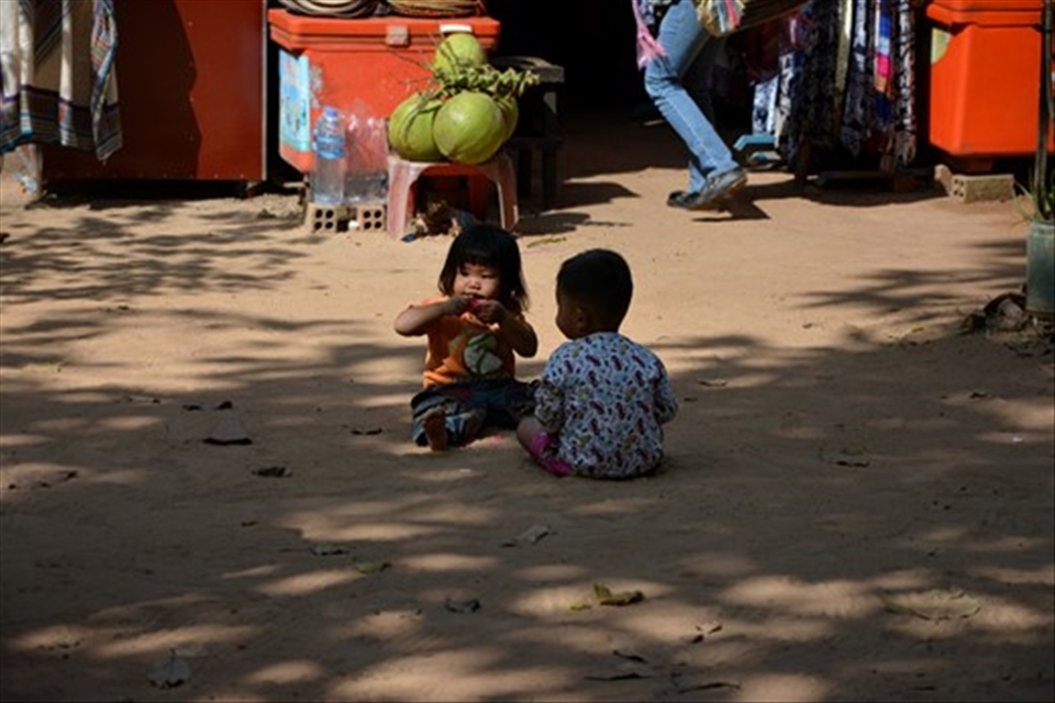 Cambodian children of workers at Angkor Wat Archeological site playing in the dust