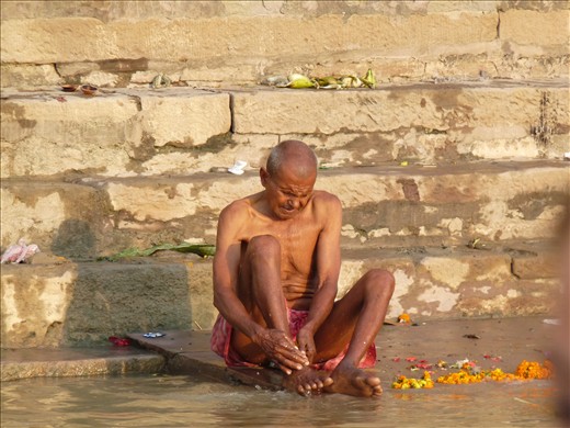 An elderly man washes himself in the river despite the fact it is heavily polluted. Bathing in the Ganges is a way to both purify the soul and pay homage to ancestors, whose ashes are often poured in its waters. 