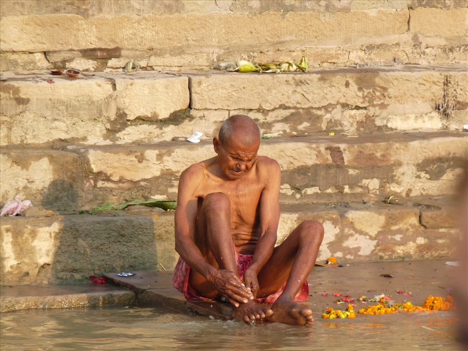 An elderly man washes himself in the river despite the fact it is heavily polluted. Bathing in the Ganges is a way to both purify the soul and pay homage to ancestors, whose ashes are often poured in its waters. 