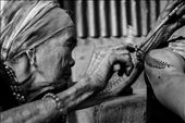 Fang-od while tattooing. Her arm is cover with full sleeve traditional: by acdimatatac, Views[342]