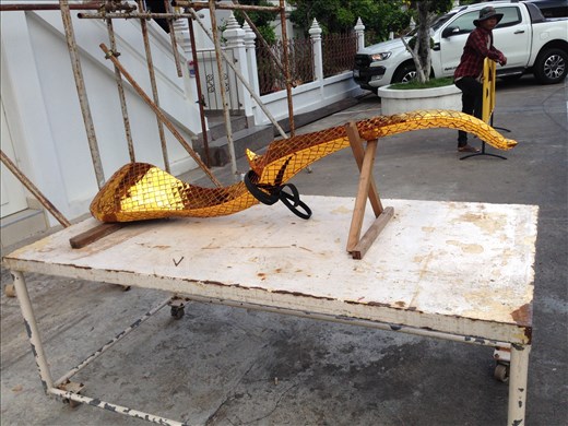 A golden wisp poised to be put up on a rooftop