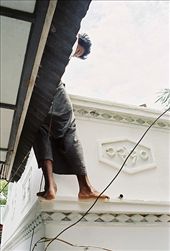 A worker cleans the roof of a temple on the outskirts of Mandalay.: by achidell, Views[343]