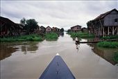A boat-man navigates the narrow waterways between raised huts on Inle lake. : by achidell, Views[325]