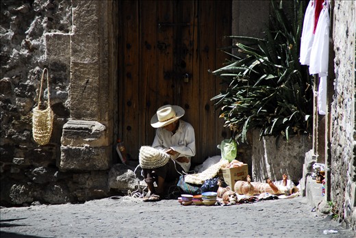 Artisans and Lovers. This artisan found a place to do some work in the doorway of an old building. He has skills in various materials. A simple life, an honest days work.
