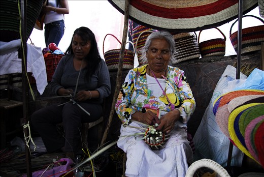 Artisans and Lovers. Here are two of the three generations weaving vibrant bold rugs and baskets in the market place behind the big old church in the town square.