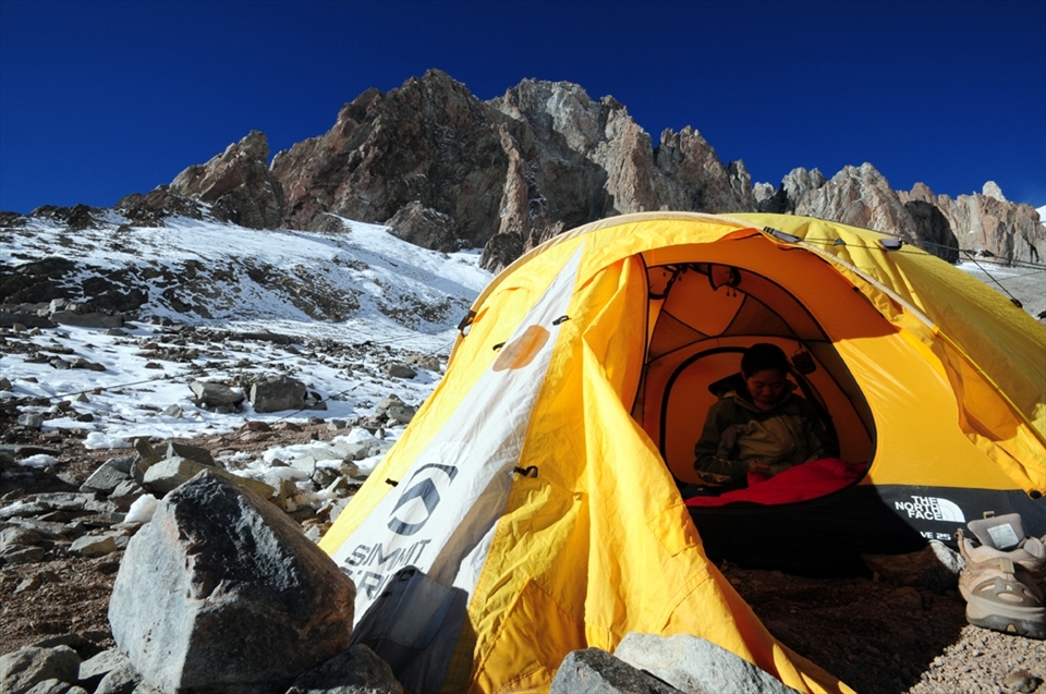 A mountaineer rests at the first of three high camps en route to the summit of Mt. Aconcagua.