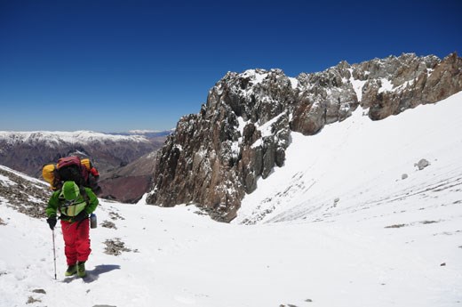 A porter hauls the equipment of an expedition up Mt. Aconcagua