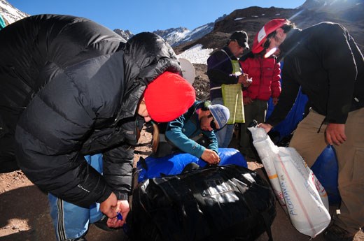 Arrieros and porters prepare for hauling the equipment of an expedition team