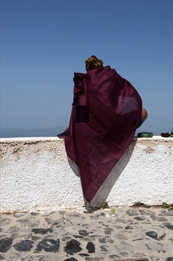 A Dutch Travelguide plays a Tibetan Soundscale in Imerovigli, Santorini, Greece