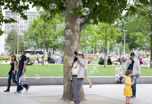 Photographer at the South Bank trying to capture some memories with the bubbles.