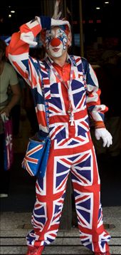 A man dressed in full Union Jack clothing, happily entertaining passersby and giving a cheesy pose for a photograph.: by adampassingham, Views[914]