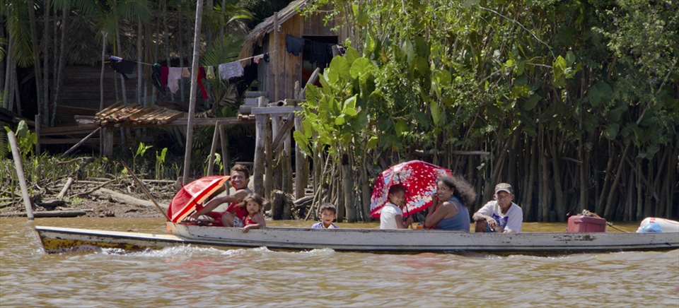 In a place without streets, a family moves around by boat.