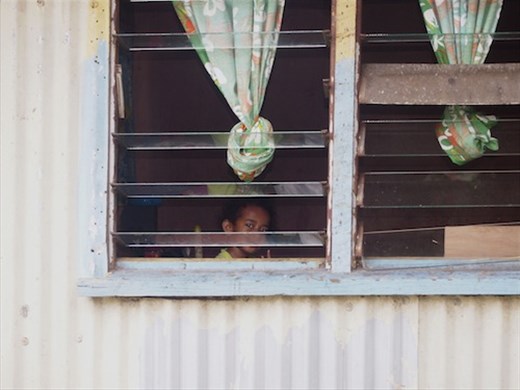 Looking out from her bedroom window this little girl has no protection