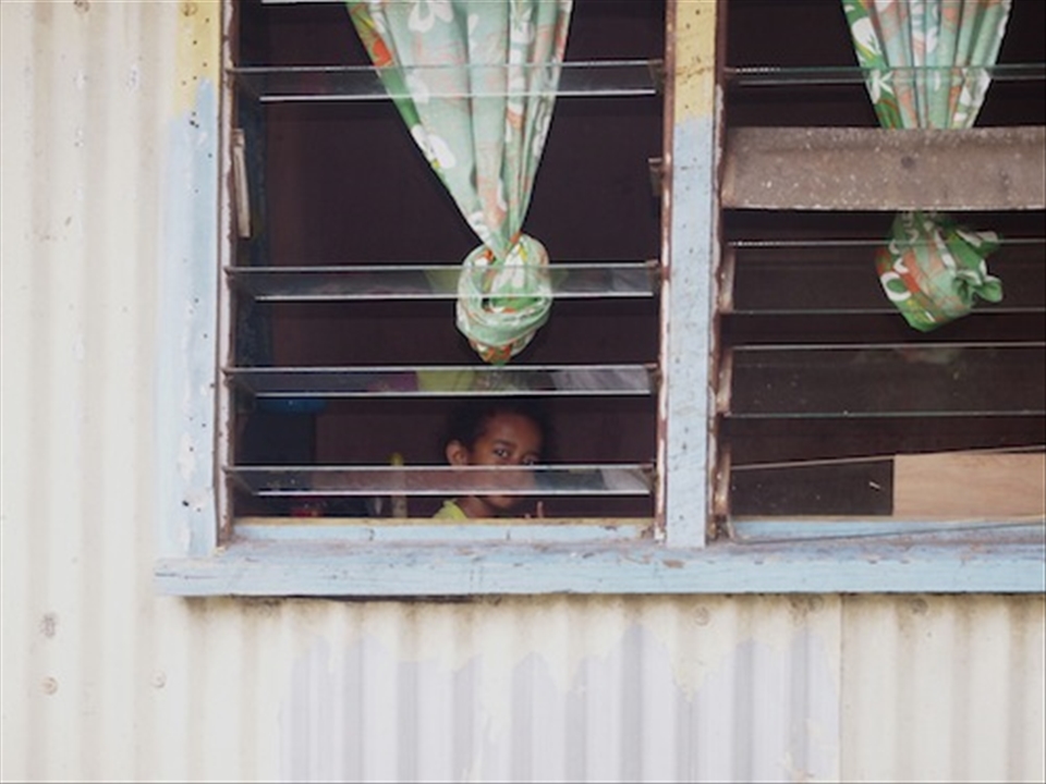 Looking out from her bedroom window this little girl has no protection