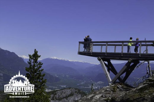 The mountains swallow the tiny town below. 